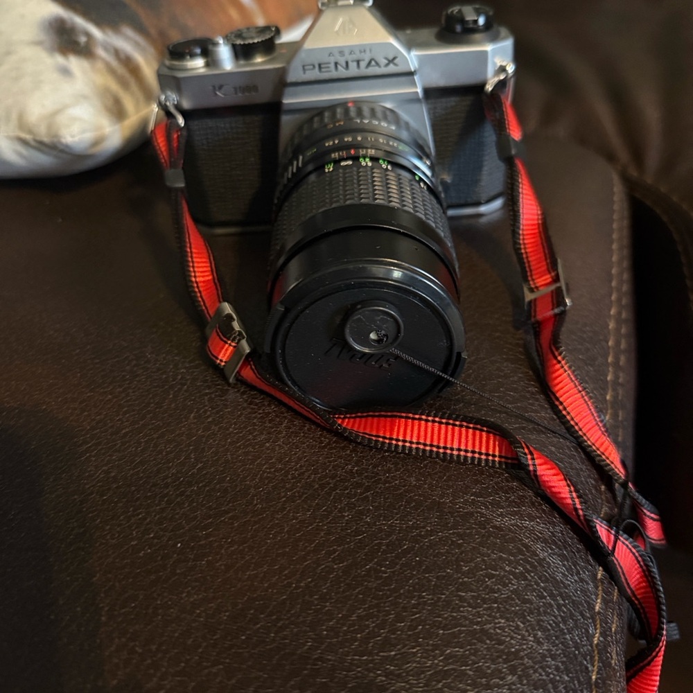 Pentax Silver Film Camera with Black Lens and Red Strap